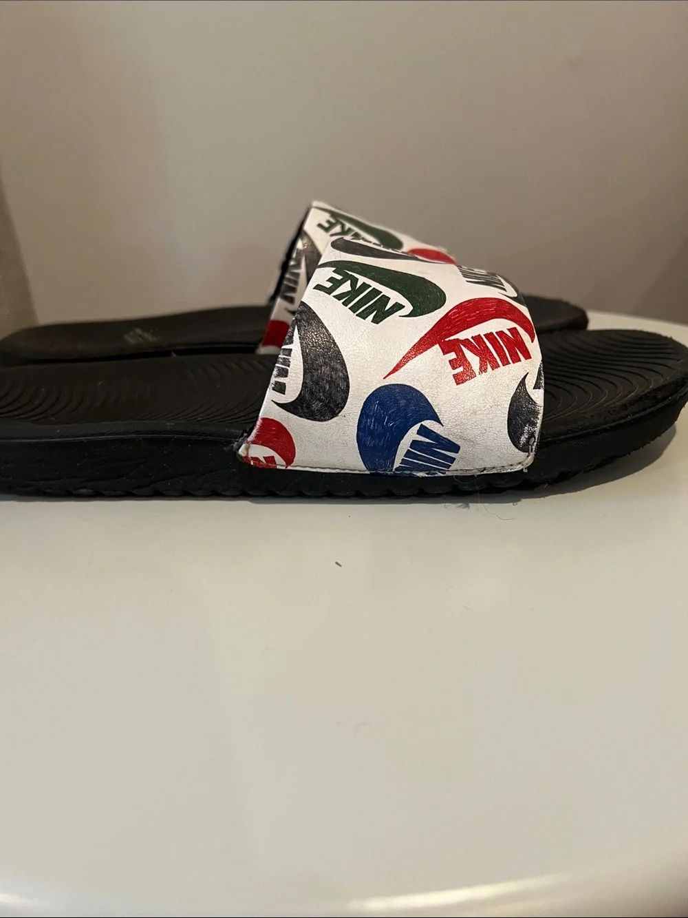Nike Kids White Slide Sandals with Red, Blue & Green Logos